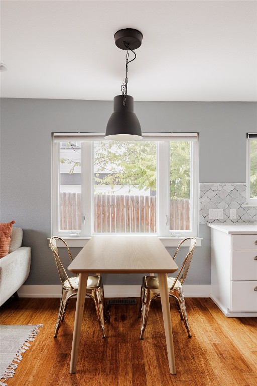 dining area with light hardwood / wood-style flooring and a wealth of natural light