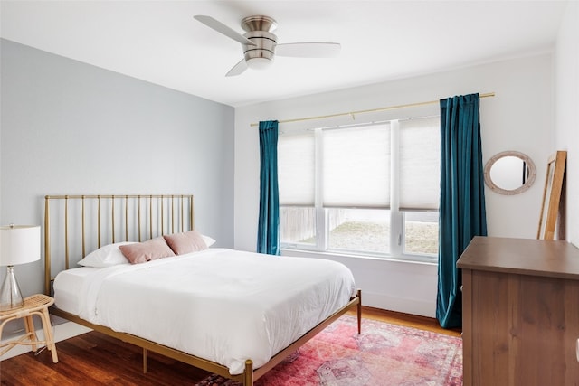 bedroom with ceiling fan and hardwood / wood-style flooring