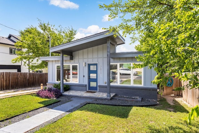 7611 Providence Ave Unit A, Austin, TX 78752 - view of front facade featuring brick siding and board and batten siding