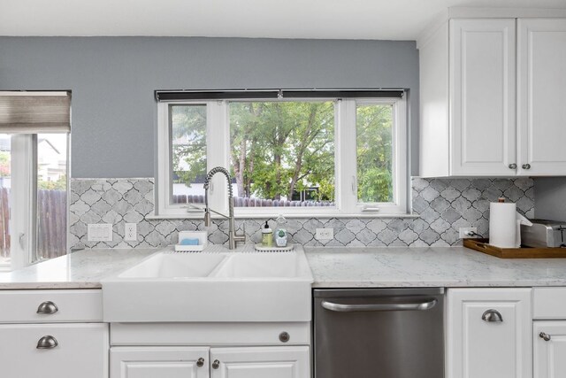 7611 Providence Ave Unit A, Austin, TX 78752 - kitchen with dishwasher, healthy amount of natural light, white cabinets, and backsplash