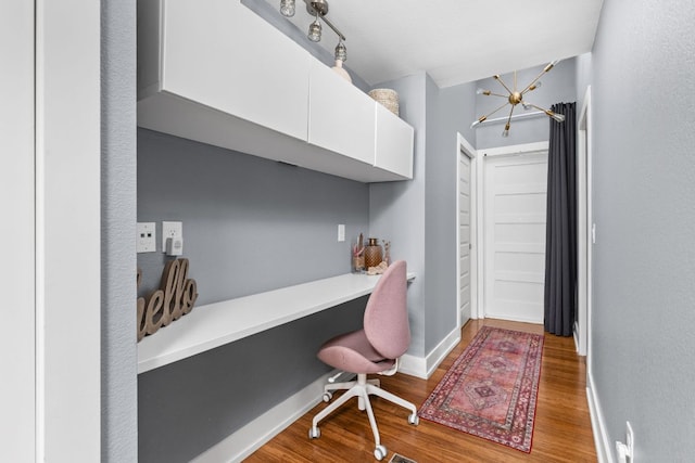 7611 Providence Ave Unit A, Austin, TX 78752 - office featuring built in study area, wood finished floors, and a chandelier