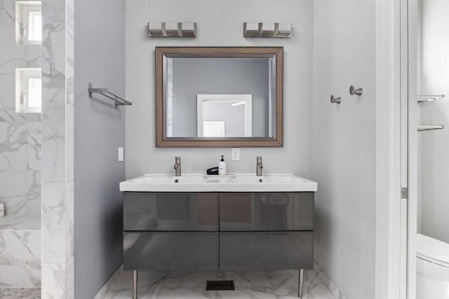7611 Providence Ave Unit A, Austin, TX 78752 - full bath featuring double vanity, marble finish flooring, and a marble finish shower