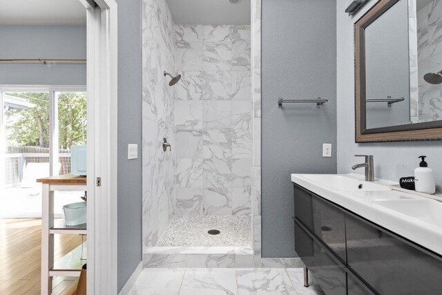 7611 Providence Ave Unit A, Austin, TX 78752 - full bath featuring a marble finish shower, double vanity, and marble look tiles