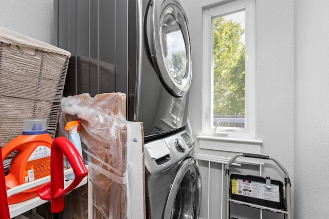 7611 Providence Ave Unit A, Austin, TX 78752 - laundry room featuring stacked washer / drying machine and a textured wall