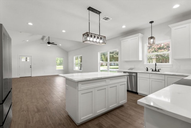 kitchen with a center island, white cabinets, vaulted ceiling, ceiling fan, and dark hardwood / wood-style flooring