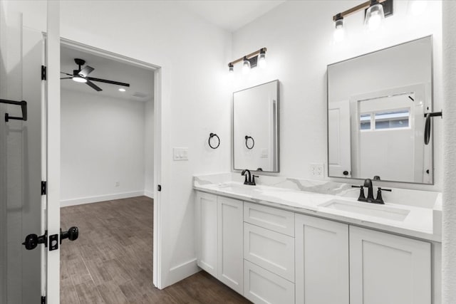 bathroom featuring hardwood / wood-style flooring, ceiling fan, and vanity