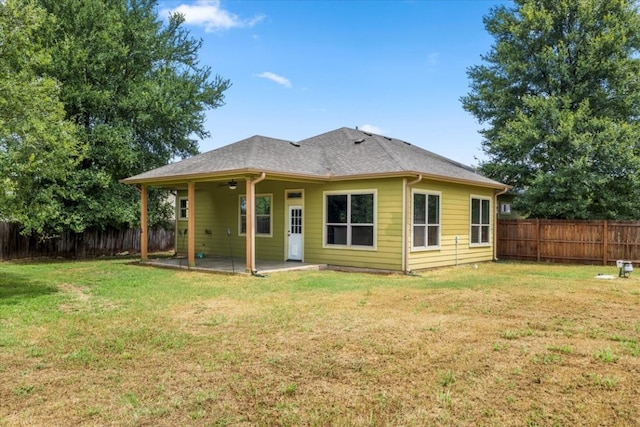 back of property featuring a lawn, ceiling fan, and a patio