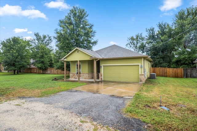 single story home with central AC, covered porch, a front yard, and a garage