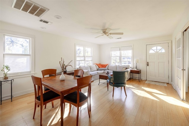 dining area with ceiling fan, plenty of natural light, and light hardwood / wood-style floors