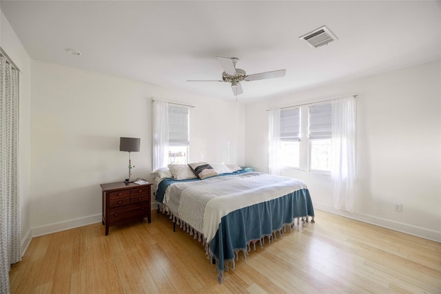 bedroom with ceiling fan and light wood-type flooring