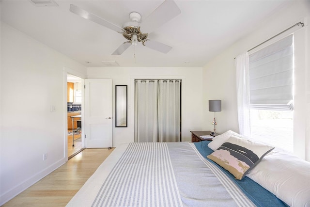 bedroom with ceiling fan and light wood-type flooring