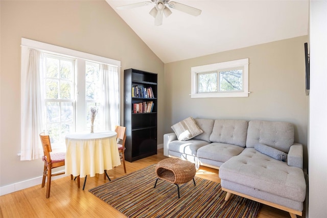 living room with hardwood / wood-style floors, ceiling fan, a healthy amount of sunlight, and high vaulted ceiling