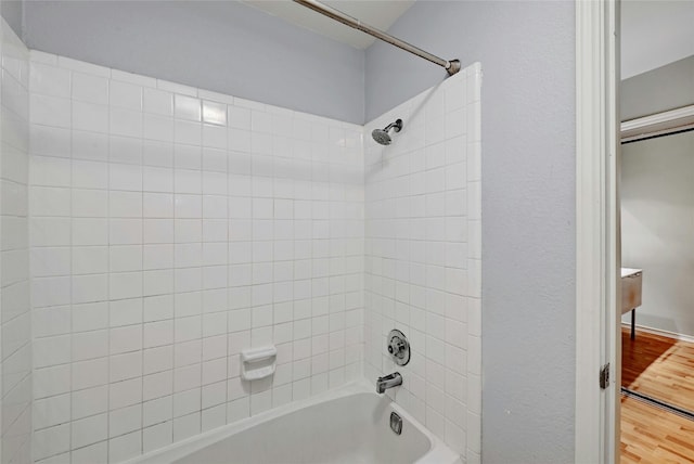 bathroom featuring shower / bath combination and hardwood / wood-style flooring