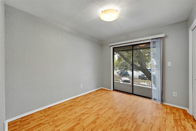 spare room with light hardwood / wood-style flooring