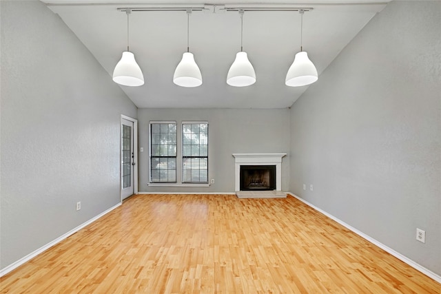 unfurnished living room with light hardwood / wood-style flooring and lofted ceiling