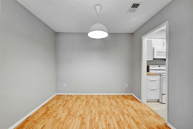 unfurnished dining area featuring wood-type flooring