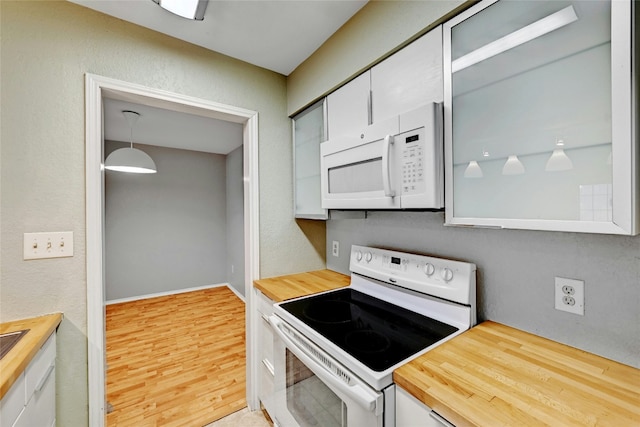 kitchen with wooden counters, white appliances, white cabinetry, and pendant lighting