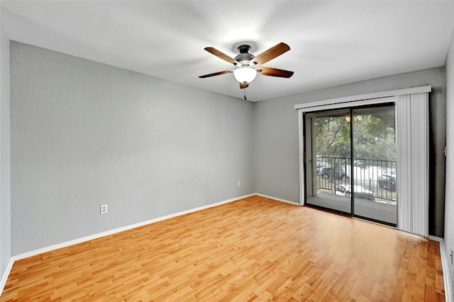 empty room with ceiling fan and light hardwood / wood-style floors