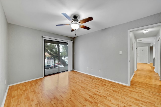 empty room with ceiling fan and light hardwood / wood-style flooring