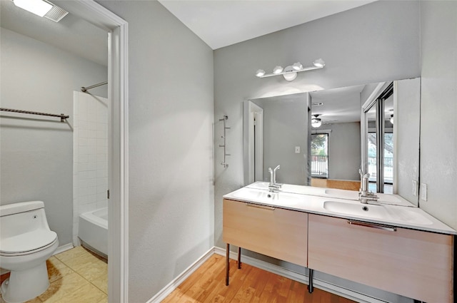 full bathroom with shower / tub combination, vanity, and toilet