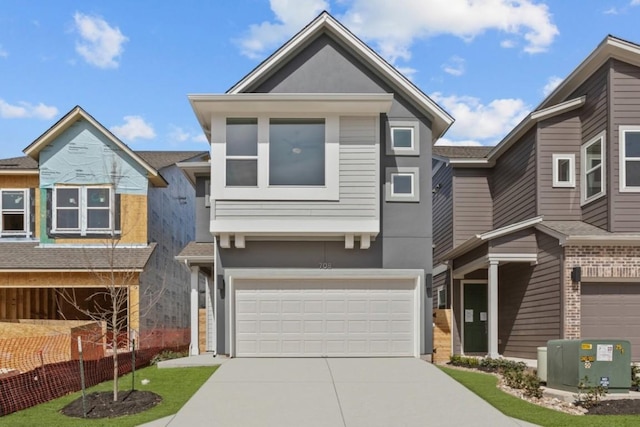 view of front of property with a garage, driveway, and stucco siding