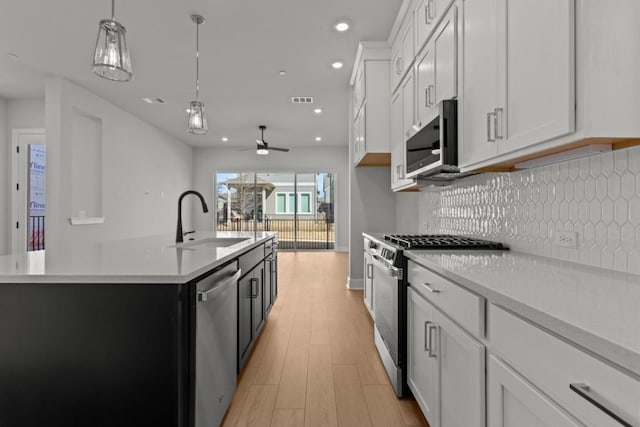 708 Terrier Trl, Austin, TX 78745 - kitchen with stainless steel appliances, light wood finished floors, backsplash, light countertops, and recessed lighting