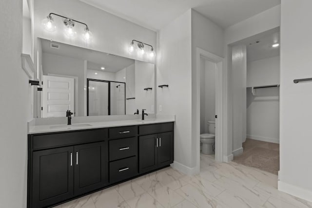 full bath featuring toilet, a sink, marble finish floor, double vanity, and a stall shower