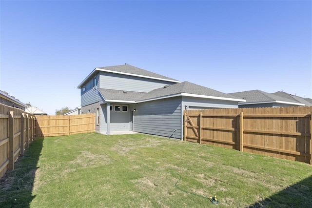 rear view of property with a yard