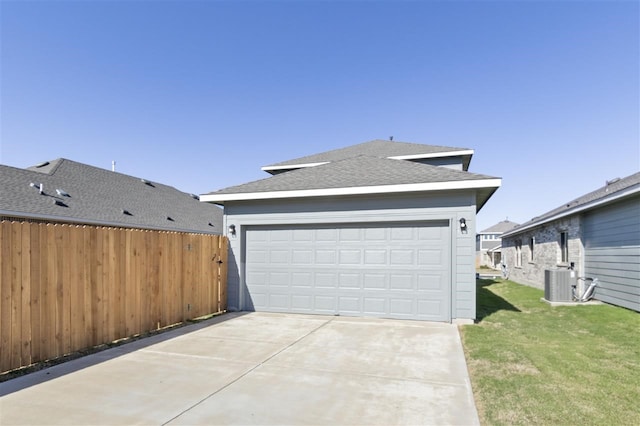 garage with cooling unit and a yard