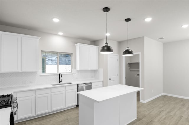 kitchen featuring decorative backsplash, sink, white cabinets, and stainless steel appliances