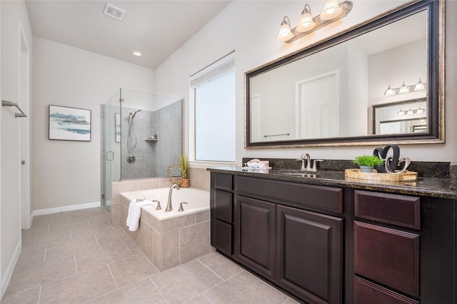 bathroom with vanity, tile patterned floors, and shower with separate bathtub