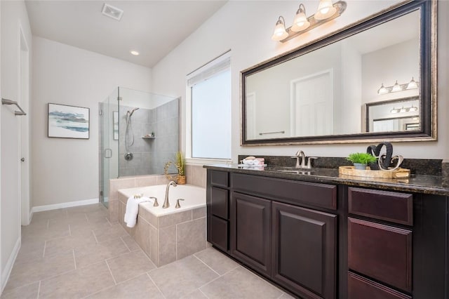 bathroom featuring tile patterned flooring, independent shower and bath, and vanity