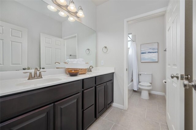 bathroom with vanity, tile patterned floors, and toilet