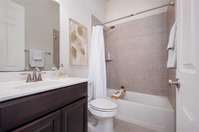 full bathroom featuring shower / tub combo, vanity, tile patterned flooring, and toilet