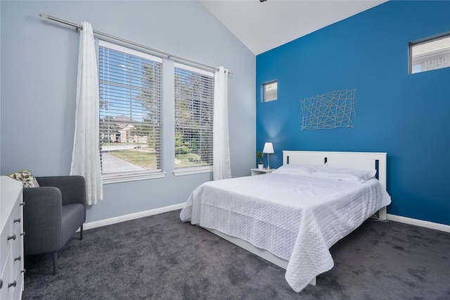 bedroom featuring lofted ceiling and dark colored carpet