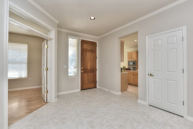 entrance foyer with crown molding and light hardwood / wood-style flooring