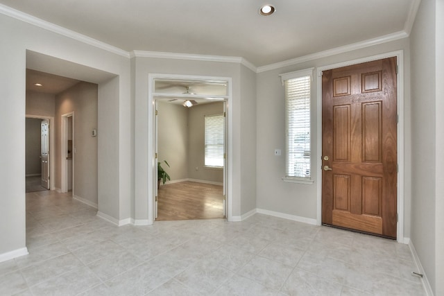 foyer entrance with ceiling fan and ornamental molding