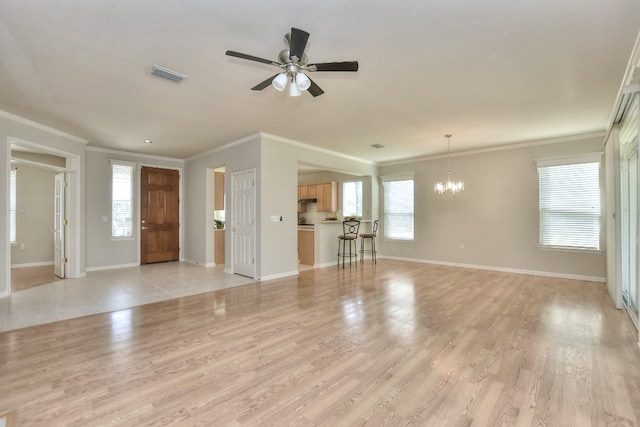 unfurnished living room featuring crown molding, a healthy amount of sunlight, and light wood-type flooring