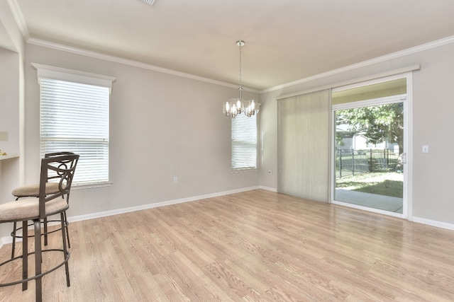 dining room with crown molding, a chandelier, and light wood-type flooring