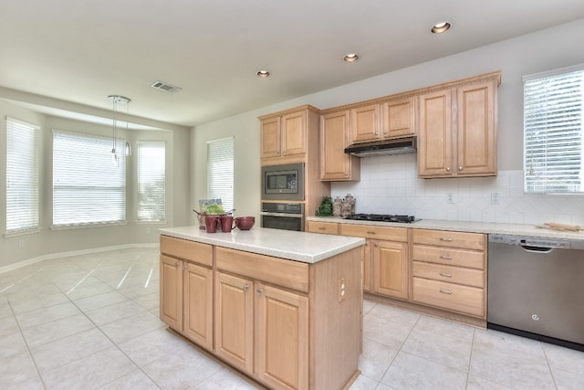 kitchen with decorative light fixtures, light brown cabinets, appliances with stainless steel finishes, and tasteful backsplash