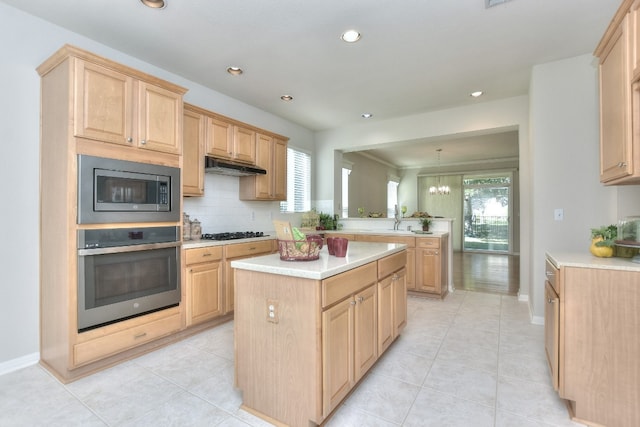 kitchen featuring light tile patterned floors, stainless steel appliances, and light brown cabinetry