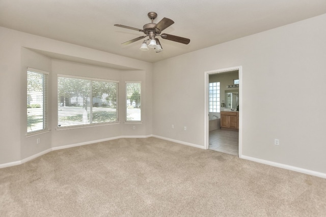 empty room with light carpet and ceiling fan