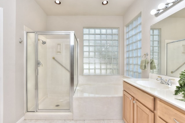 bathroom featuring tile patterned floors, separate shower and tub, and vanity