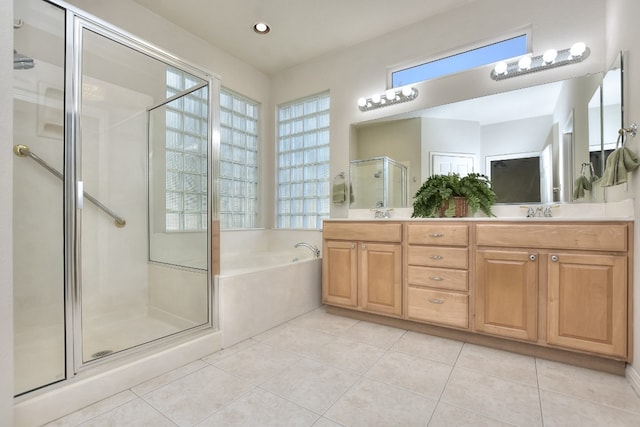 bathroom featuring tile patterned floors, separate shower and tub, and vanity