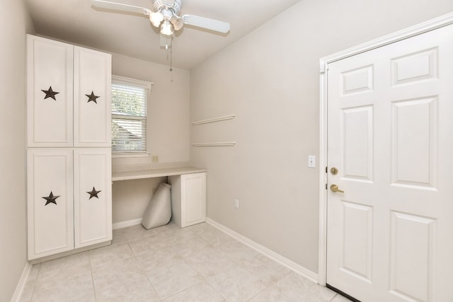 clothes washing area with ceiling fan and light tile patterned floors