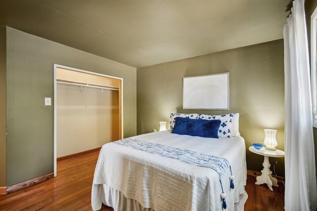 bedroom featuring hardwood / wood-style floors and a closet