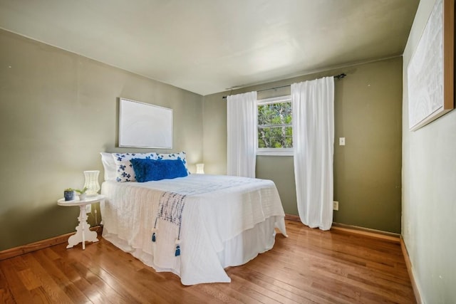 192 Carmen Hill Ln, Bastrop, TX 78602 - bedroom featuring baseboards and wood finished floors