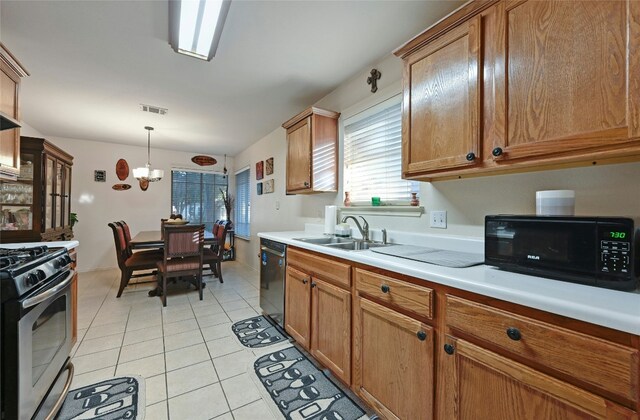 kitchen with sink, hanging light fixtures, a chandelier, light tile patterned floors, and black appliances