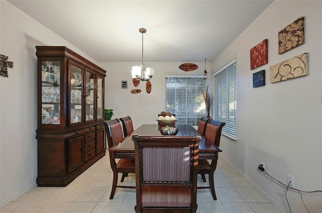 tiled dining room featuring a notable chandelier