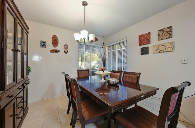 tiled dining space with a notable chandelier